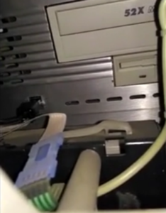 A still from a video posted on a DDW forum, allegedly showing the insertion of a USB stick into an ATM as part of a malware injection jackpotting attack.